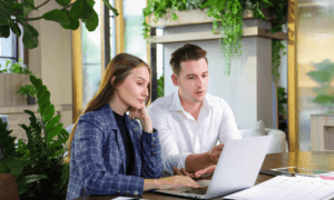 Two people looking at a computer