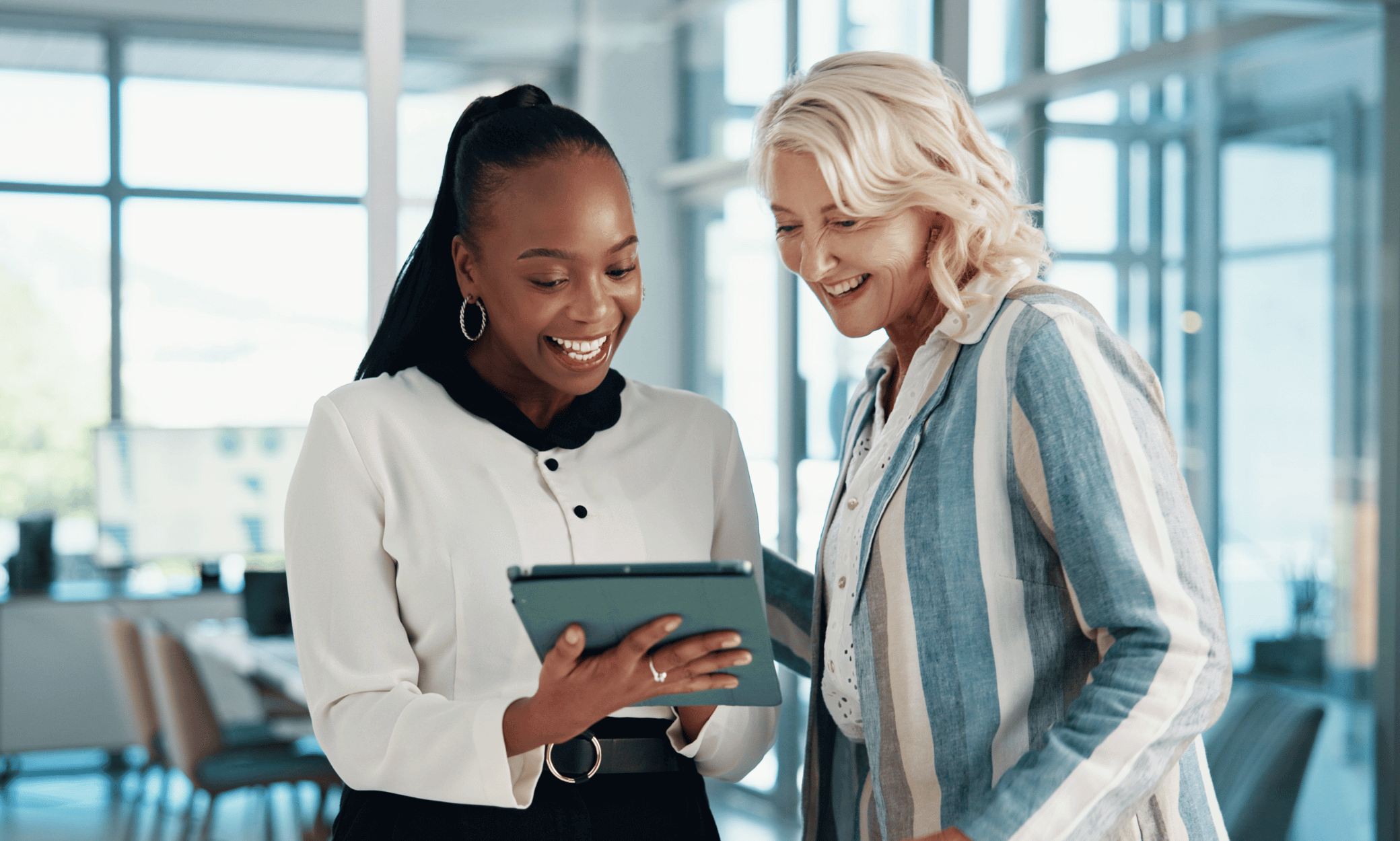 Two people looking at a tablet.